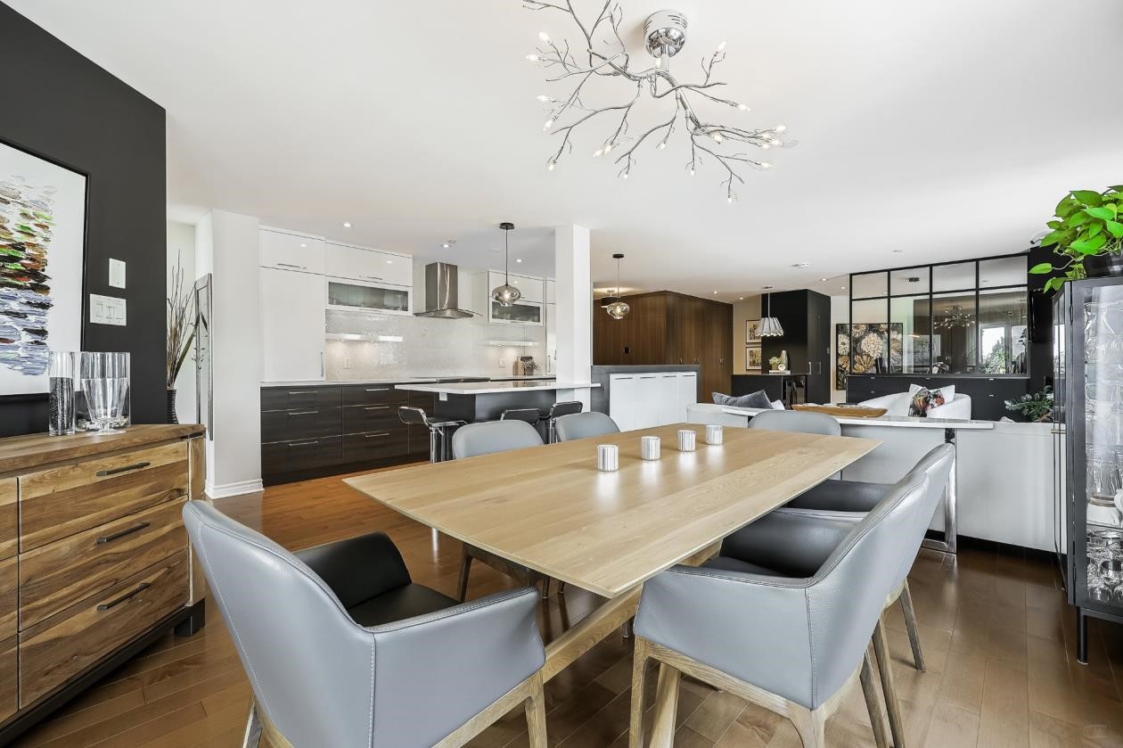 Salle à manger avec table en bois naturel et fauteuils en tissus gris